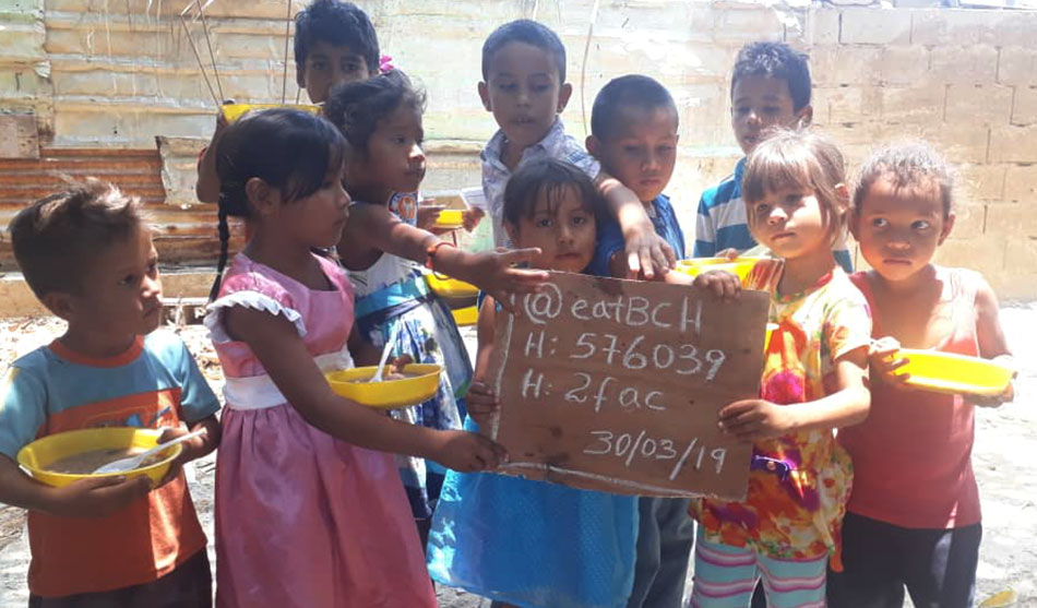 Kids with food holding a sign with "@eatBCH".